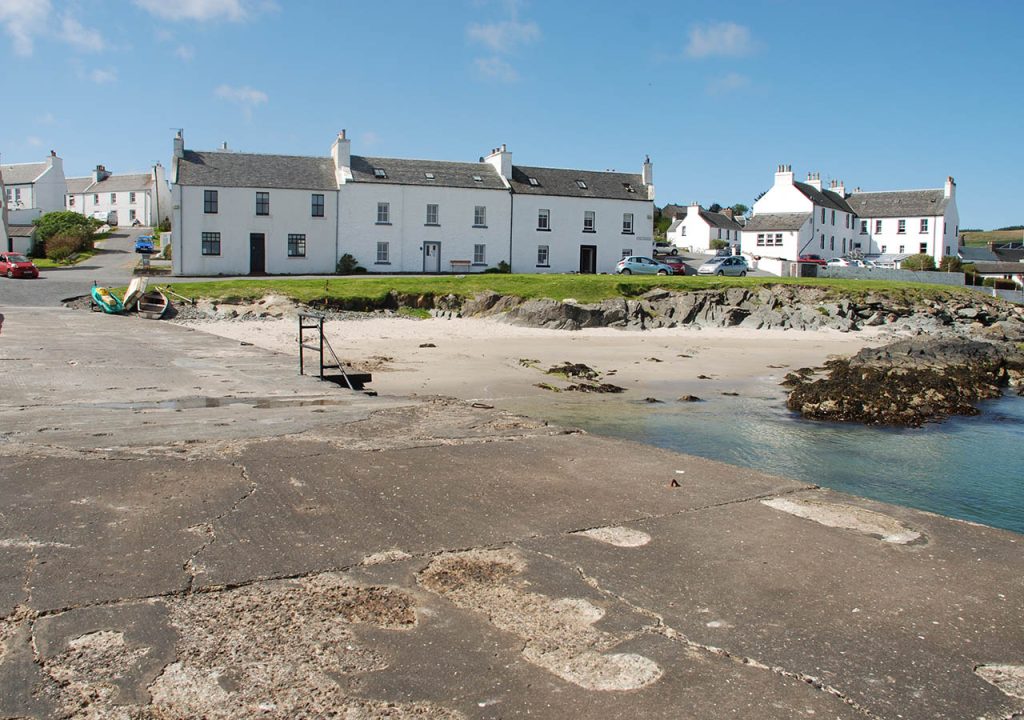 The pretty houses of Port Charlotte on Islay overlooking the beach