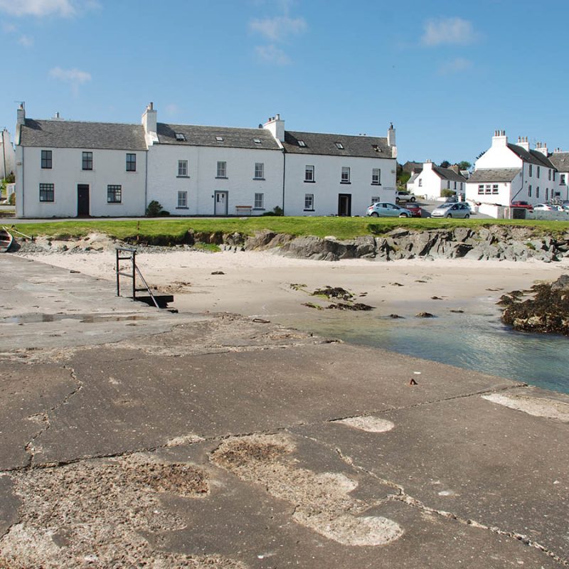 The pretty houses of Port Charlotte on Islay overlooking the beach